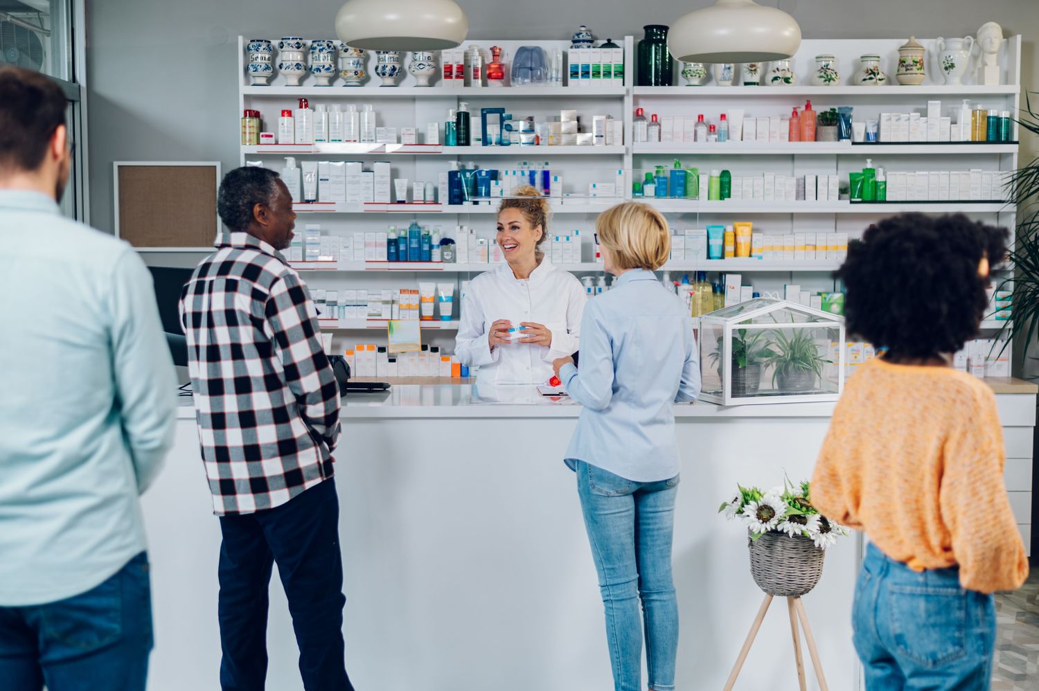Pharmacist helping customers at a pharmacy counter